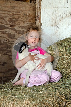 Farm girl with baby goat