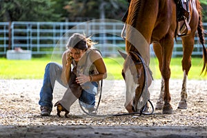 Farm girl on phone with horse and dog