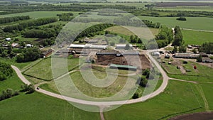 A farm with green meadows and fields