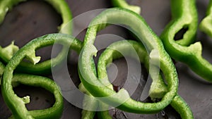 Farm grown green bell pepper slice falling in slow motion.