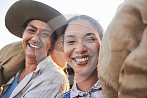 Farm harvest, women portrait and countryside with a smile from working on a grass field with grain bag. Sustainability