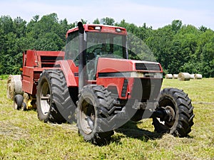 Farm: haymaking tractor and baler photo