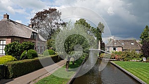 Farm house at canal in romantic water village Giethoorn in the Netherlands