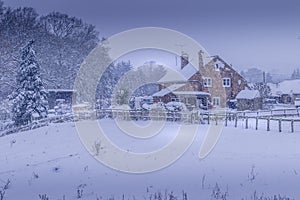 Farm house cottage during Christmas winter snow storm