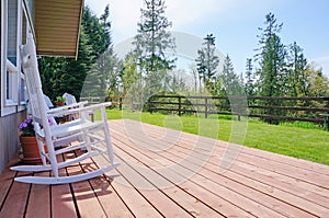 Farm house open front deck with white chairs