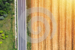 Farm land aerial view from above near country road, drone view ladnscape. Crops concept