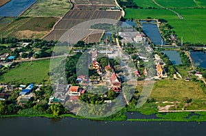 Farm land, rice fields and Buddhist temple aerial photo in Thailand