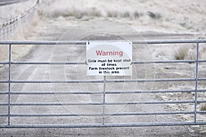 Farm livestock in area warning sign keep gate shut at farm