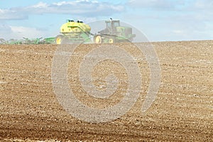 Farm equipment planting wheat in the fertile farm fields of Idaho.