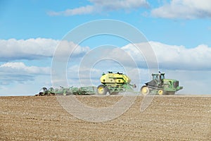 Farm equipment planting wheat in the fertile farm fields of Idaho.