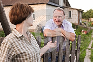 Farm neighbors talking at the fence