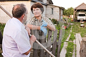 Farm neighbors talking at the fence