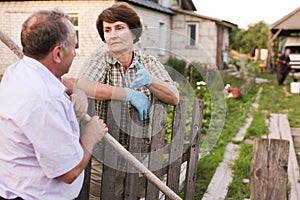 Farm neighbors talking at fence