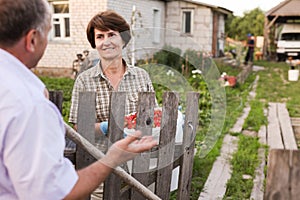 Farm neighbors talking at the fence