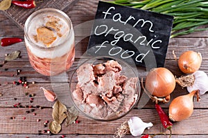 Farm organic food. Canned meat in a glass jar on a wooden background