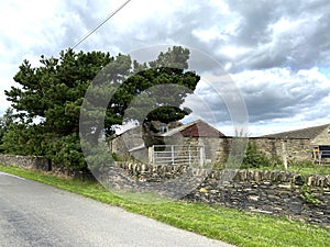 Farm with outbuildings and a cloudy sky on, Lower Wyke Lane, Bradford, Yorkshire, UK