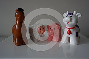 Farm plastic animals on white shelf