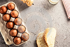 Farm raw fresh egg in pack bread milk on gray table scrambled eggs omelet fried egg