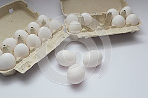 Farm raw fresh egg in pack on white table. Open egg boxes with white eggs isolated on white background with clipping path