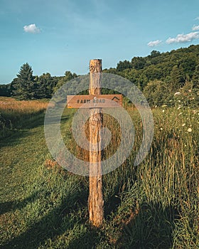 Farm Road sign in a meadow at the Mohonk Preserve, in the Shawangunk Mountains, New York