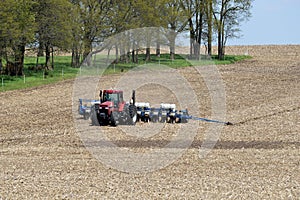 Farm scene with a tractor seeding farm fields