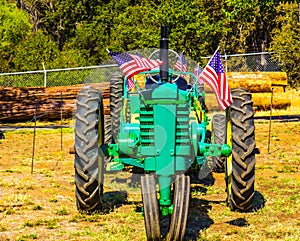 Farm Tractor With American Flags At Small County Fair