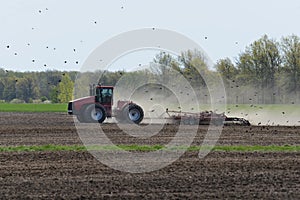 Farm tractor pulling a cultivator preparing to plant the spring crop