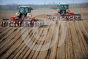 Farm tractors planting field