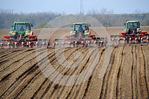 Farm tractors planting field