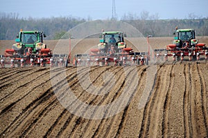 Farm tractors planting field photo