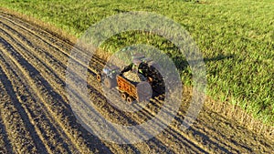 Farm Tractors working on sugar cane harvest plantation aerial view