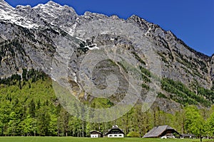 Farm in valley at a mountain massif photo
