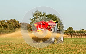 Farm Vehicle spreading lime sandstone onto a field