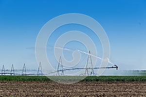 Farm water irrigation system sprays water on the field