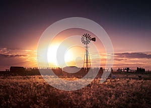 Farm and Windmill at Sunset