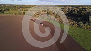 farm work, germany tractor dive on fall field. Gorgeous aerial view flight drone