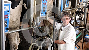 Farm Worker Milking Cows