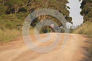 Farm worker walking home along the gravel road