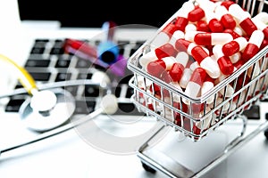 shopping cart with white and red capsules in the foreground photo