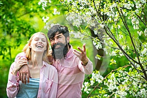 Farmars couple enjoy spring nature and take care about her plants. Happy Couple Farmers working with spud on spring