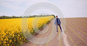 Farmer or Agronomist Walking on Agrculture Field and Looking at Crops