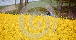 Farmer or Agronomist Walking on Agrculture Field and Looking at Crops