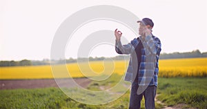 Farmer or Agronomist Walking on Agrculture Field and Looking at Crops