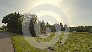 A farmer in Bavaria cuts the grass in a field in summer. Farmer with agricultural equipment mows the meadow and makes