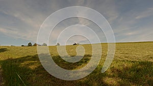 A farmer in Bavaria cuts the grass in a field in summer. Farmer with agricultural equipment mows the meadow and makes