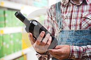 Farmer buying wine at supermarket