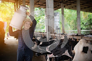 Farmer carrying kettle full of milk