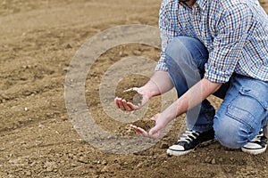 Farmer Checking Soil Quality of Fertile Agricultural Farm Land