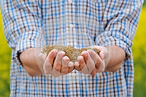 Farmer Checking Soil Quality of Fertile Agricultural Farm Land