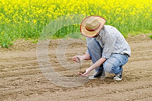 Farmer Checking Soil Quality of Fertile Agricultural Farm Land